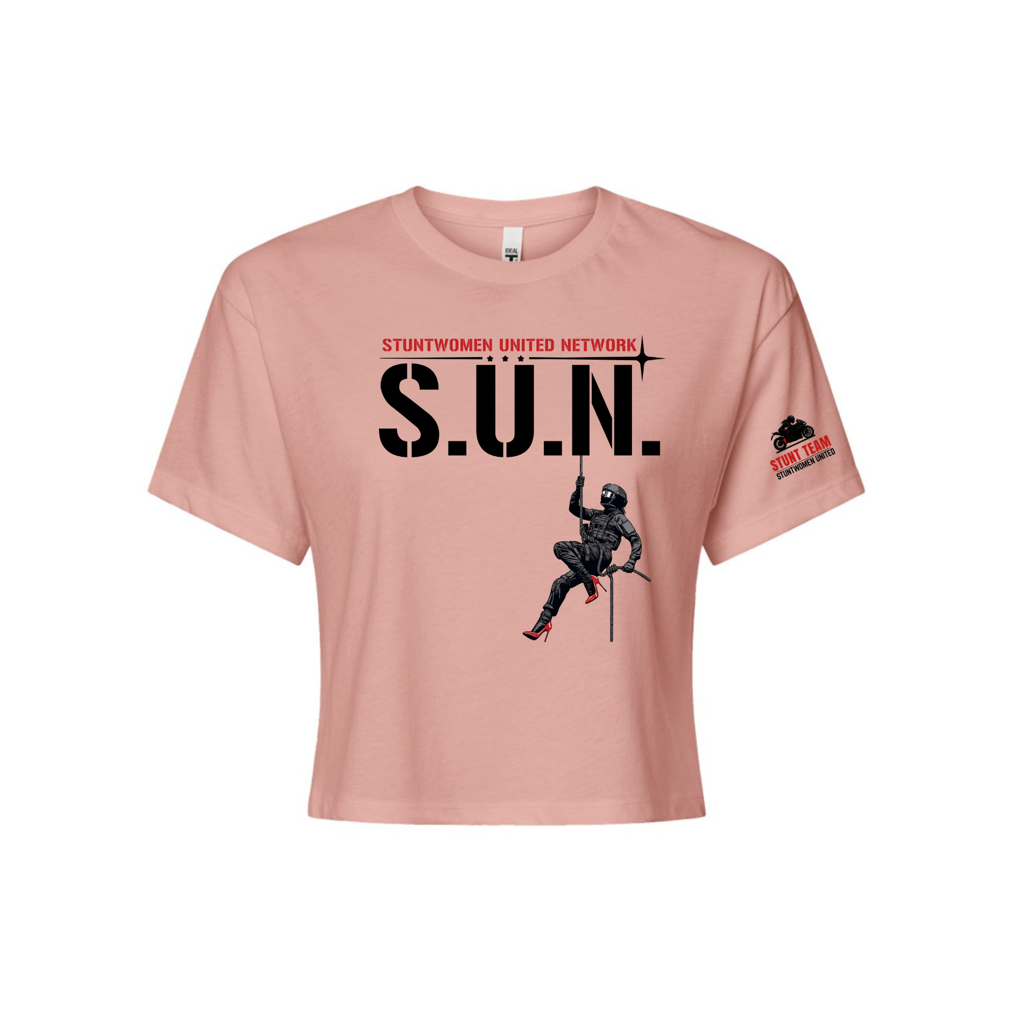 Stuntwomen United light pink women’s cropped T-shirt shown from the front, featuring S.U.N. logo with rappelling stuntwoman graphic in red heels and Stunt Team sleeve logo.