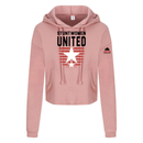 Stuntwomen United blush pink women’s cropped hoodie shown from the front, featuring bold STUNTWOMEN UNITED text with distressed red stripe star graphic.