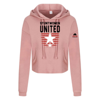 Stuntwomen United blush pink women’s cropped hoodie shown from the front, featuring bold STUNTWOMEN UNITED text with distressed red stripe star graphic.